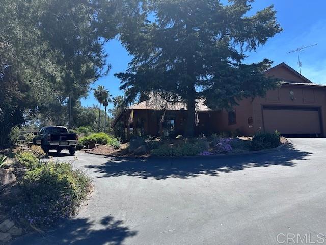 12993 Old Barona Road Lakeside, CA 92040 - Photo 25 of 48 a view of a house with truck parked on a road