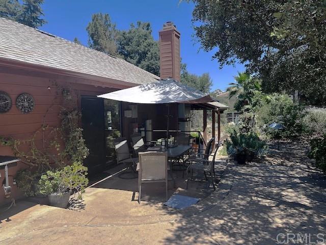12993 Old Barona Road Lakeside, CA 92040 - Photo 38 of 48 a view of a patio with table and chairs potted plants