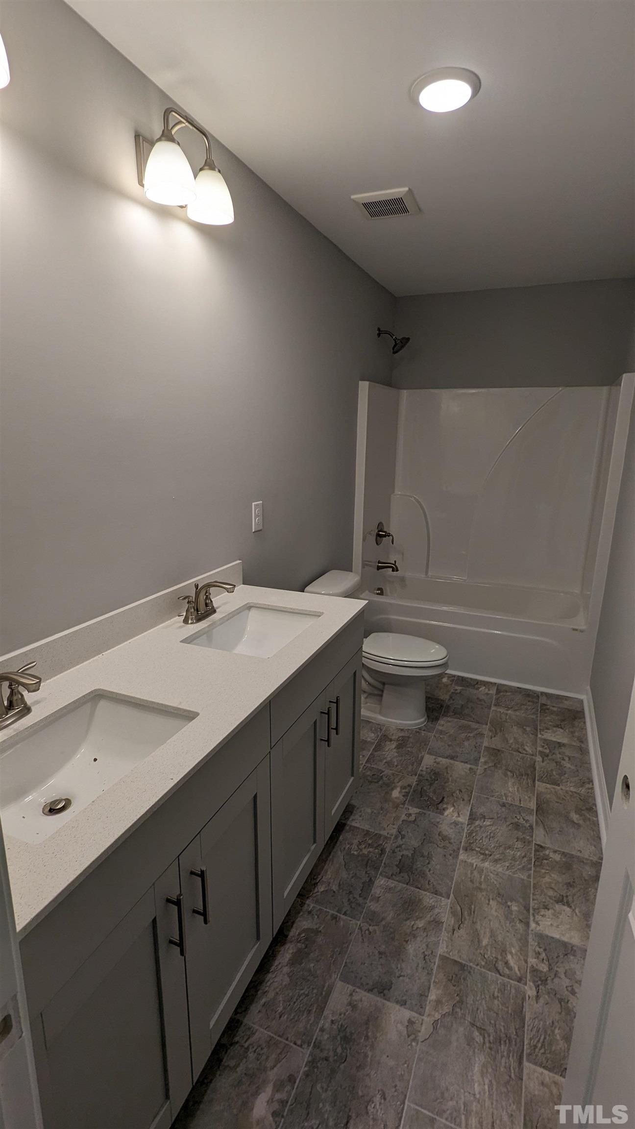 32 Daffodil Garden Court Smithfield, NC 27577 - Photo 12 of 19 a bathroom with a sink a toilet and a mirror