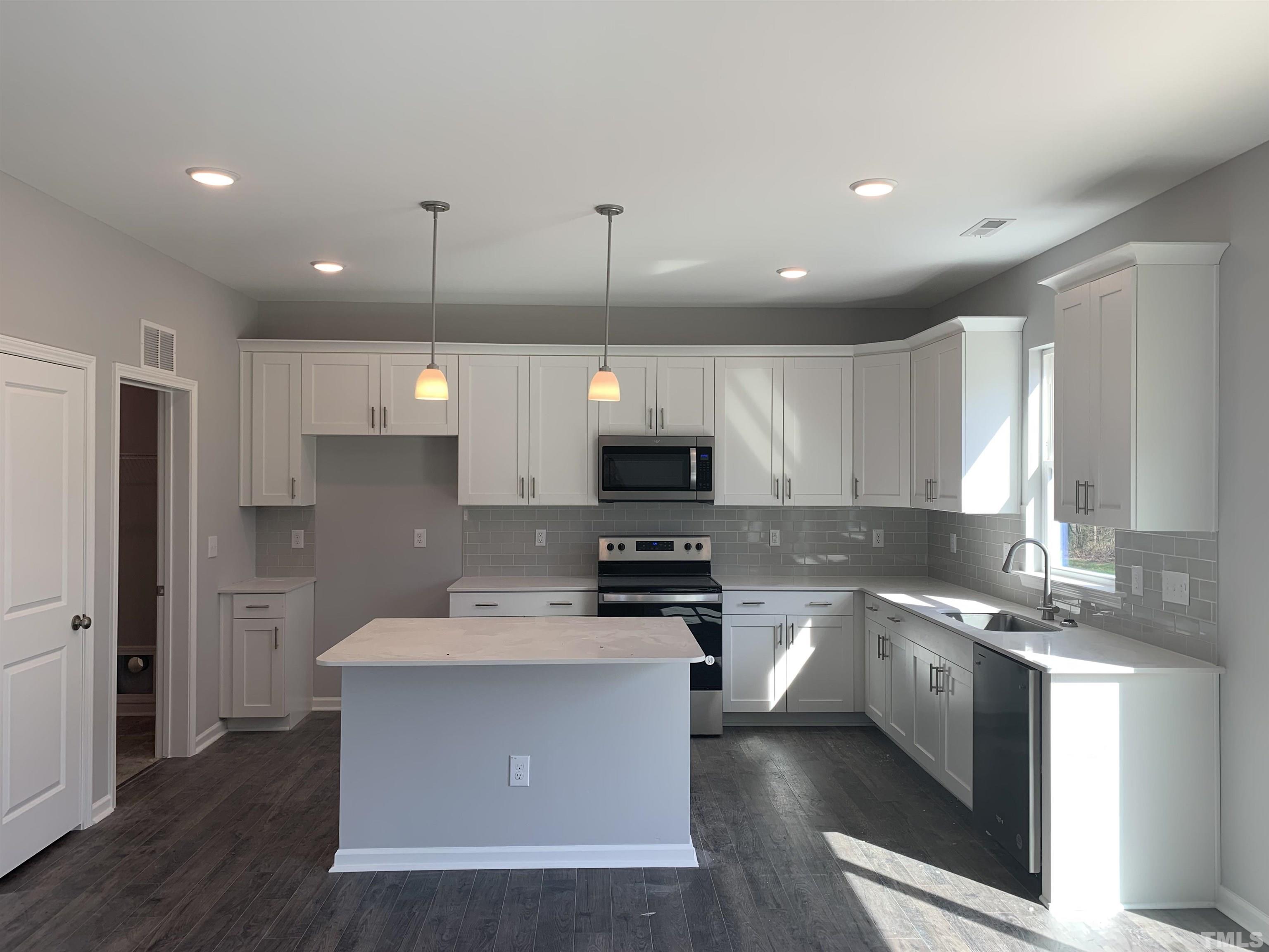 32 Daffodil Garden Court Smithfield, NC 27577 - Photo 5 of 19 a kitchen with a sink stainless steel appliances and cabinets