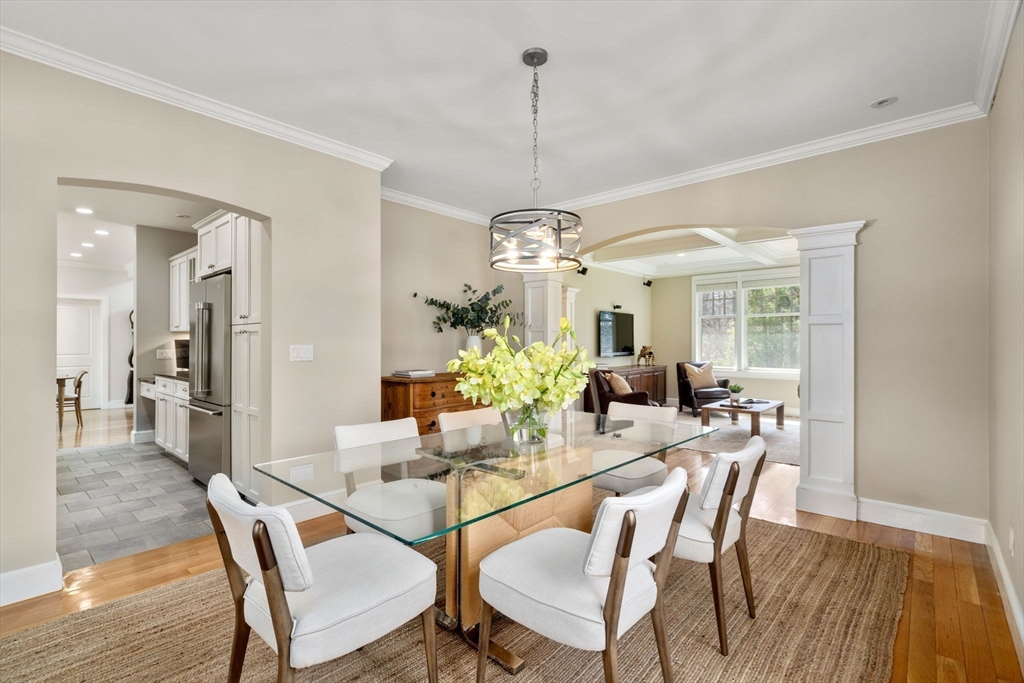 45 Sherman's Bridge Road Wayland, MA 01778 - Photo 12 of 20 a dining room with furniture a chandelier and wooden floor