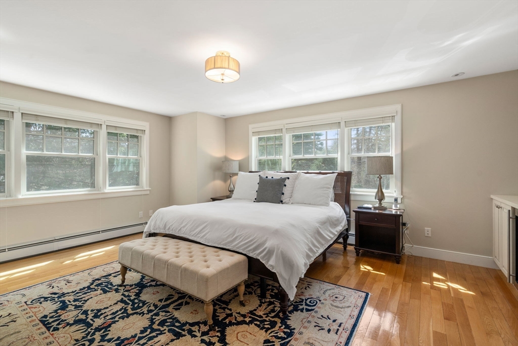 45 Sherman's Bridge Road Wayland, MA 01778 - Photo 18 of 20 a bedroom with a bed and wooden floor