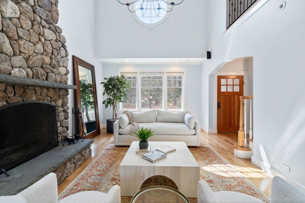 45 Sherman's Bridge Road Wayland, MA 01778 - Photo 8 of 20 a living room with furniture windows and a fireplace