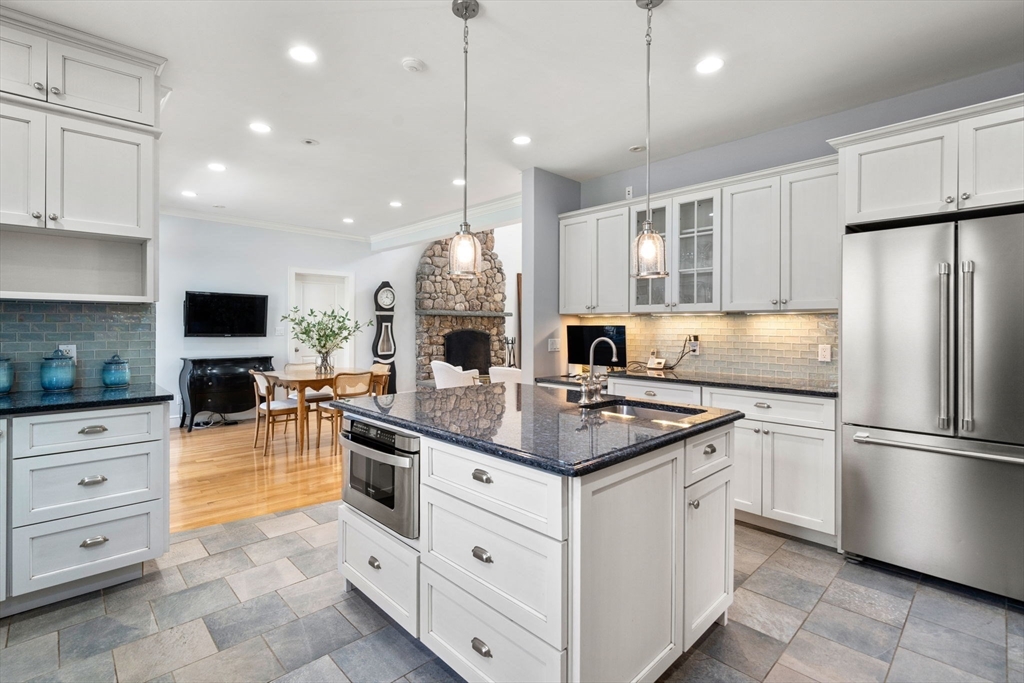 45 Sherman's Bridge Road Wayland, MA 01778 - Photo 10 of 20 a kitchen with white cabinets and stainless steel appliances