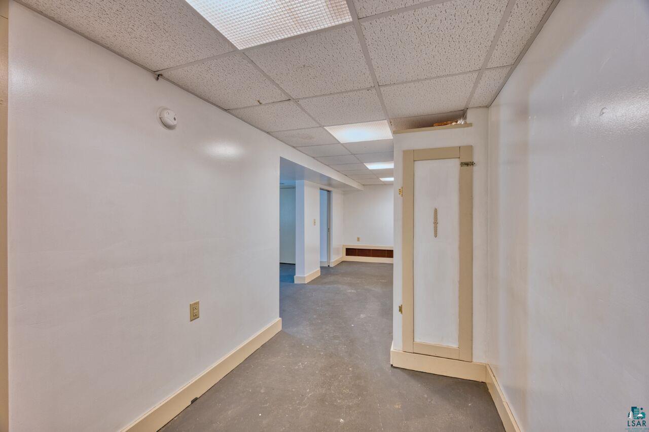 4191 Kerr Location Hibbing, MN 55746 - Photo 15 of 37 Finished basement with a drop ceiling and baseboards