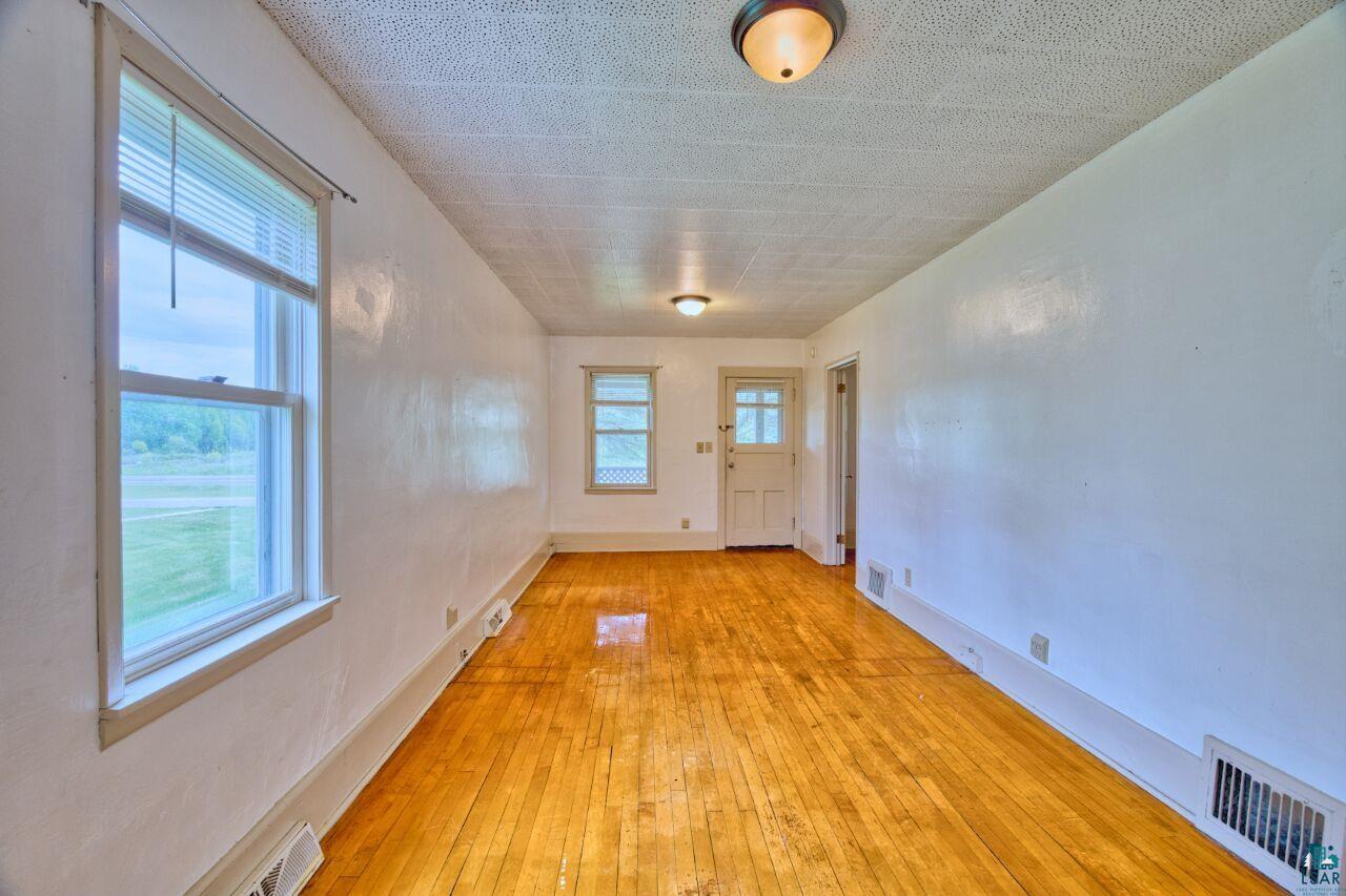 4191 Kerr Location Hibbing, MN 55746 - Photo 2 of 37 Unfurnished room with light wood-style flooring and baseboards