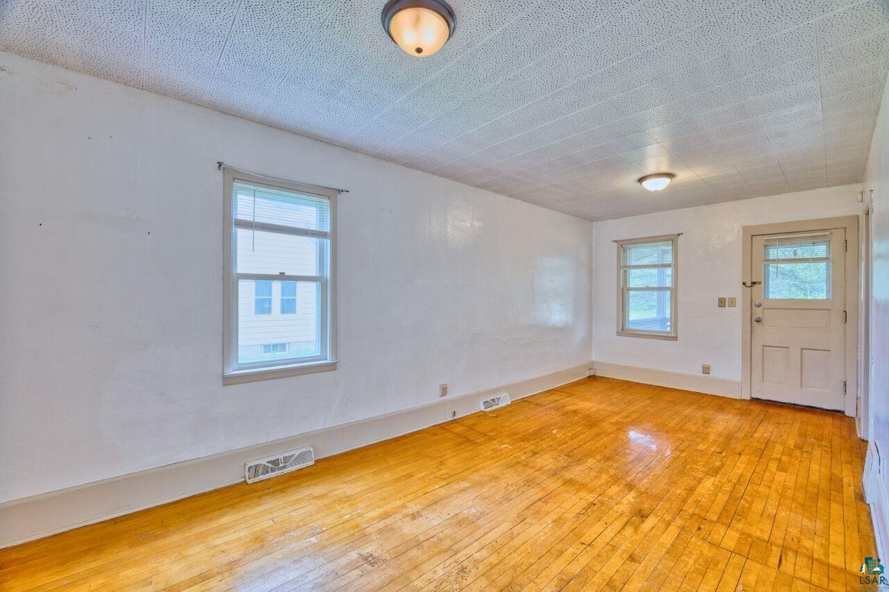 4191 Kerr Location Hibbing, MN 55746 - Photo 4 of 37 Unfurnished room with hardwood / wood-style flooring