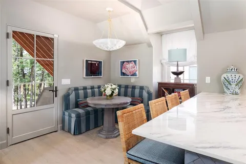 a kitchen with stainless steel appliances granite countertop a sink a stove and a wooden floor