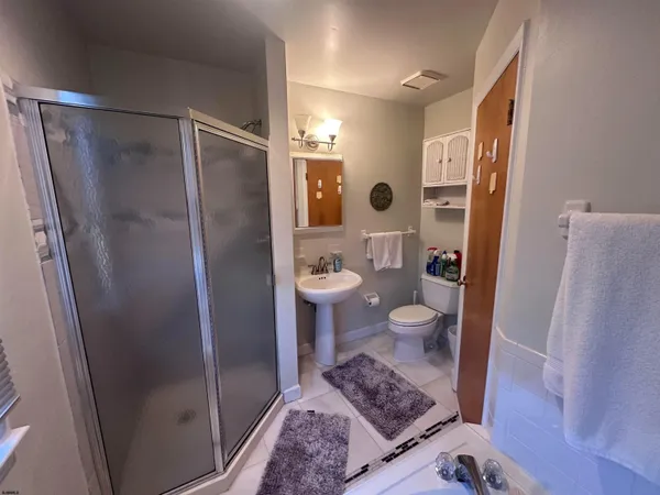 a bathroom with a sink toilet and shower