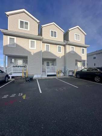 a front view of a residential apartment building with a street