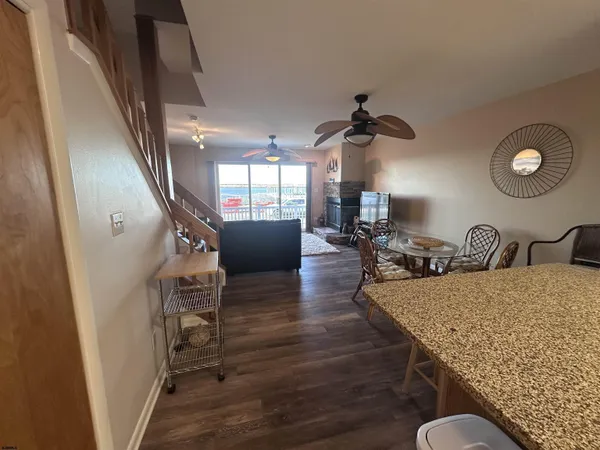 a view of a livingroom with furniture hardwood floor and staircase