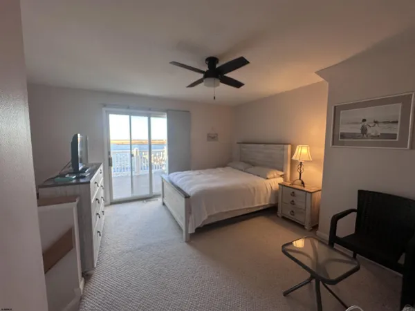 a bedroom with a bed and a television