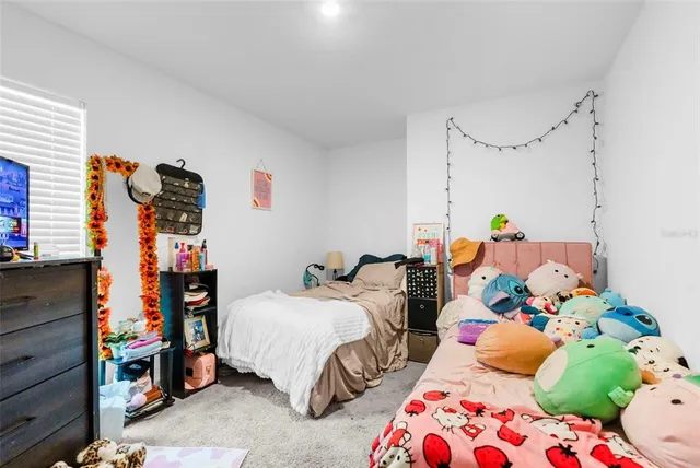 a bedroom with two beds and a chandelier