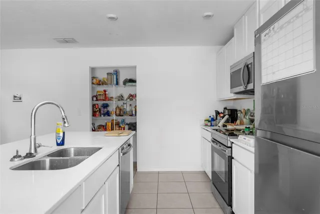 a kitchen with a sink a stove and cabinets