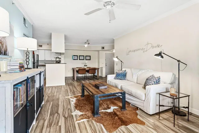 a living room with furniture and a kitchen view