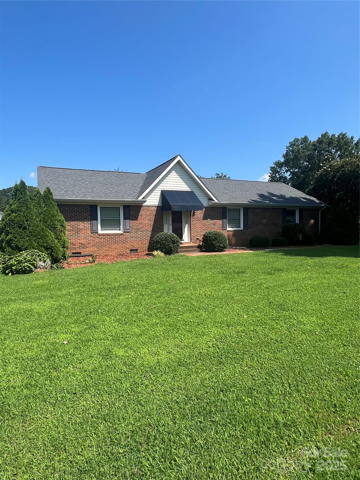 a front view of house with yard and green space