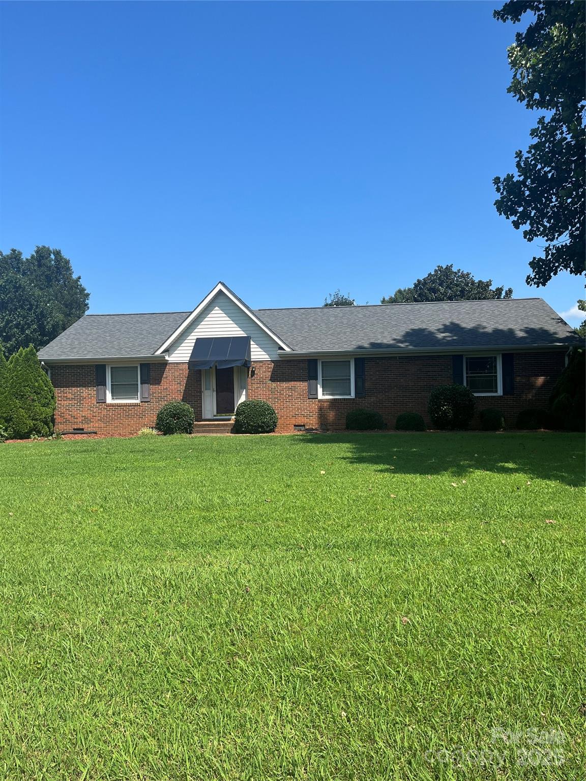 35209 Beth Road Albemarle, NC 28001 - Photo 2 of 38 a front view of a house with a garden and porch