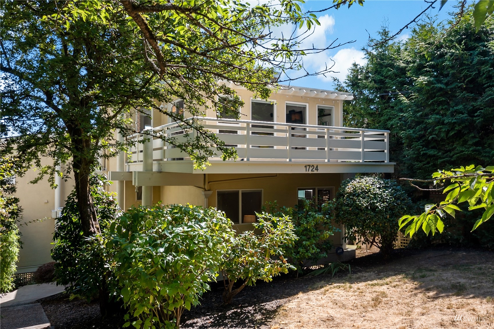 a front view of a house with a garden