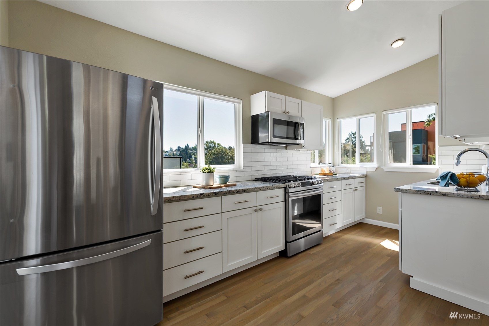 1724 26th Avenue Seattle, WA 98122 - Photo 15 of 37 a kitchen with stainless steel appliances a refrigerator sink and microwave