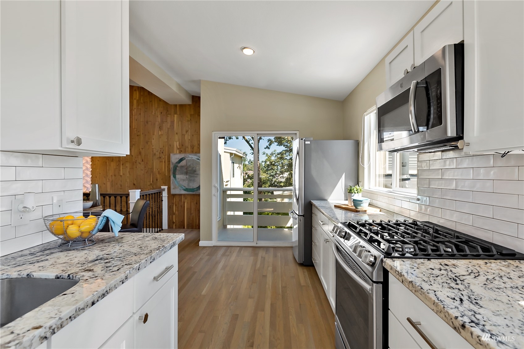 1724 26th Avenue Seattle, WA 98122 - Photo 17 of 37 a kitchen with stainless steel appliances granite countertop a stove a sink and a microwave