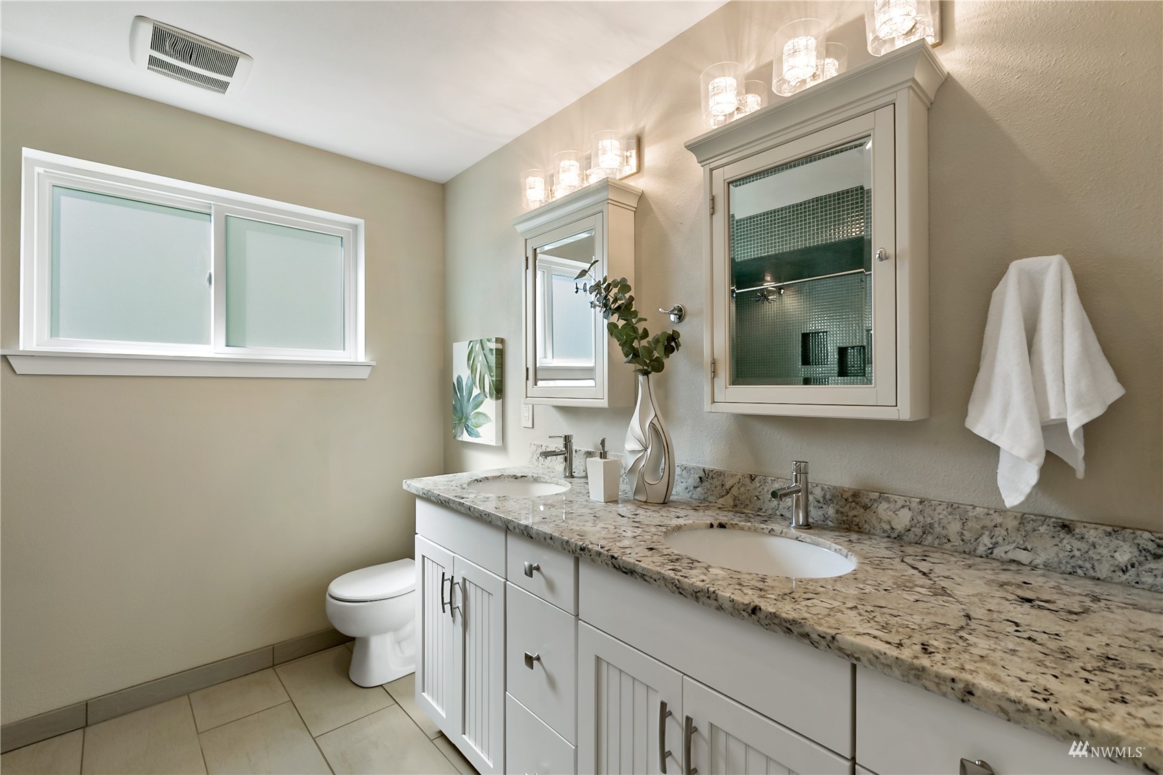 1724 26th Avenue Seattle, WA 98122 - Photo 24 of 37 a bathroom with a granite countertop sink mirror vanity and toilet