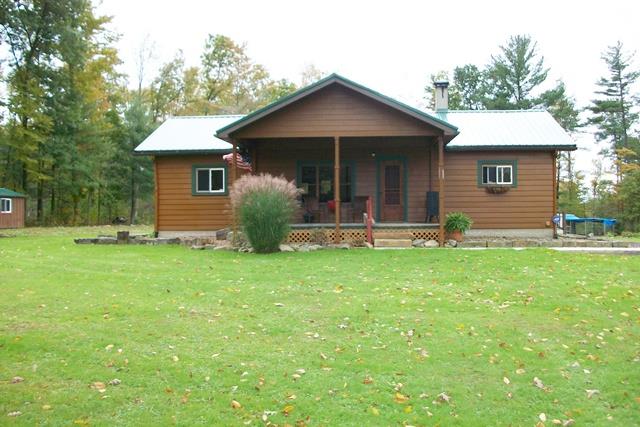 394 Dewoody Road Polk, PA 16342 - Photo 1 of 1 a front view of a house with a yard