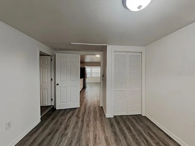 a view of hallway with wooden floor