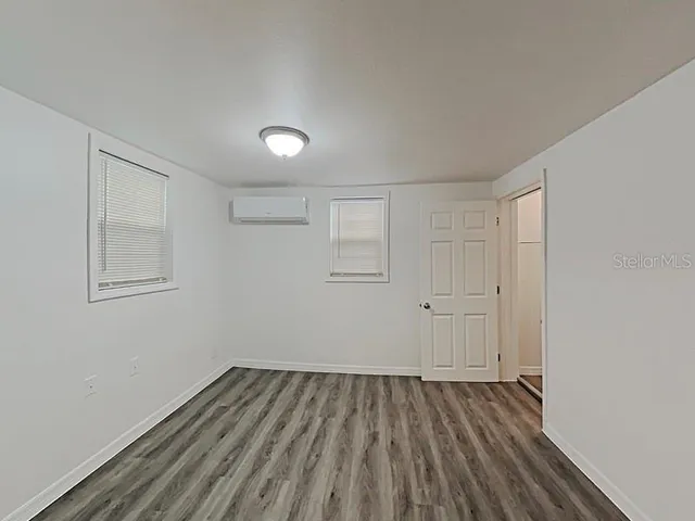 a view of a room with wooden floor and white walls