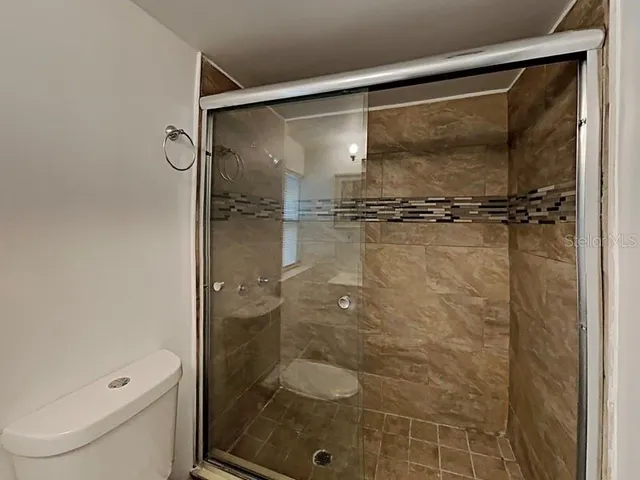 a bathroom with a glass shower door