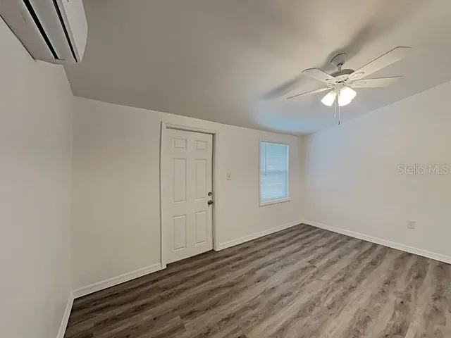 a view of room with window and ceiling fan