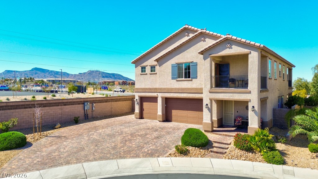Mediterranean style home.  Front porch with additional stairs walk way leading from sidewalk.  Breathtaking Mountain views and open space surround this magnificent Multi-generational Next Gen residence.  Stucco Exterior.  South and East facing Balcony.  Three Car garage.  Expanded Driveway can fit 7 vehicles.