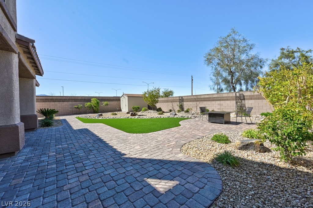 1054 Langston Ranch Avenue Henderson, NV 89002 - Photo 13 of 82 Fenced backyard featuring a patio and a storage shed
