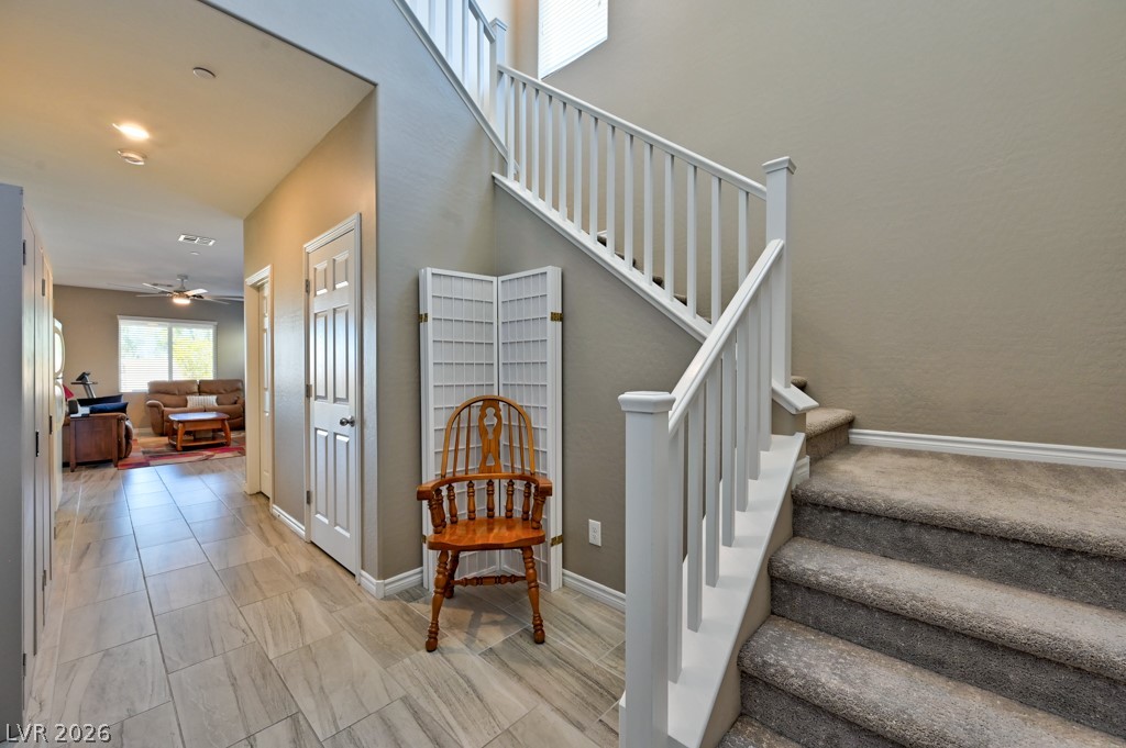 1054 Langston Ranch Avenue Henderson, NV 89002 - Photo 14 of 82 Front Entry way is spacious with high ceilings and Staircase with white painted wood spindles.