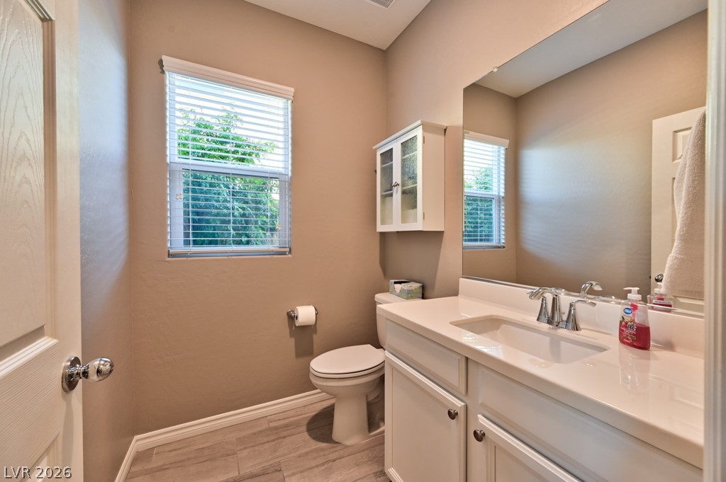 1054 Langston Ranch Avenue Henderson, NV 89002 - Photo 15 of 82 Guest Hall Half bath with vanity and light tile flooring
