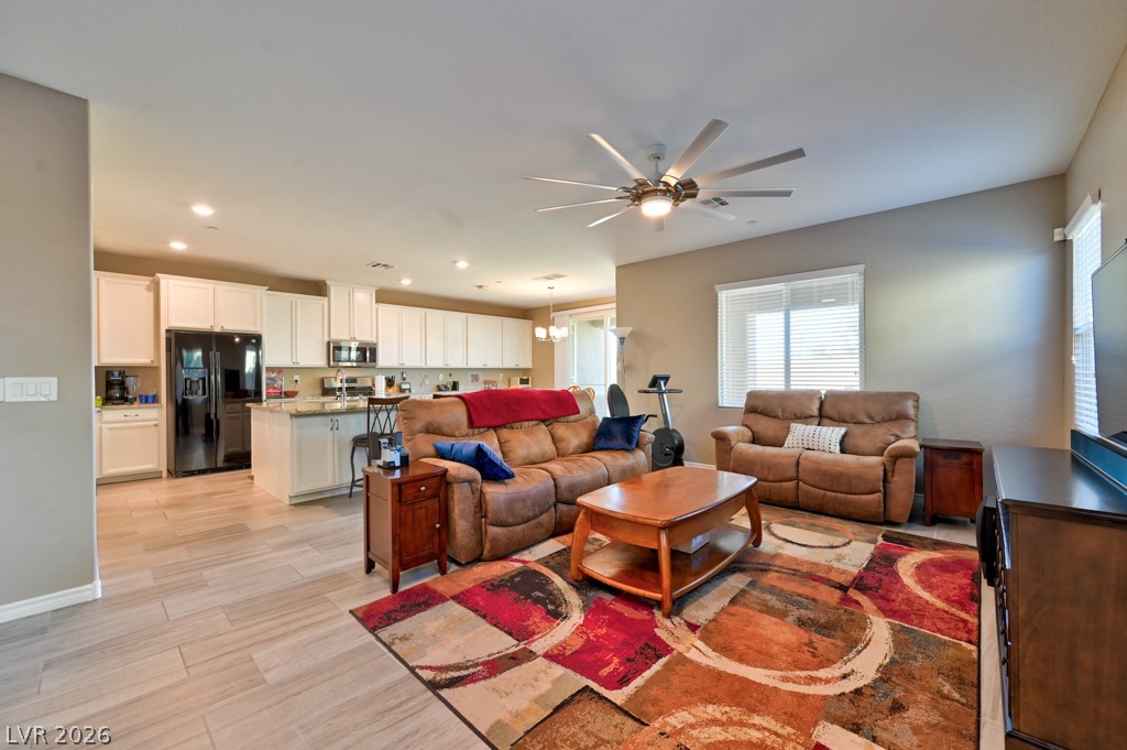 1054 Langston Ranch Avenue Henderson, NV 89002 - Photo 16 of 82 Large Great room Living area with a lighted ceiling fan and modern style tile flooring