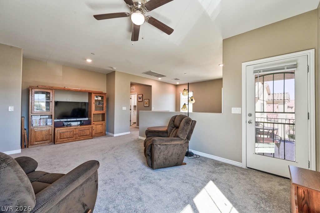 1054 Langston Ranch Avenue Henderson, NV 89002 - Photo 35 of 82 Loft. Security door leads to balcony. Pony wall overlook the downstairs entry way. Back area leads to the Primary Main bedroom suite.