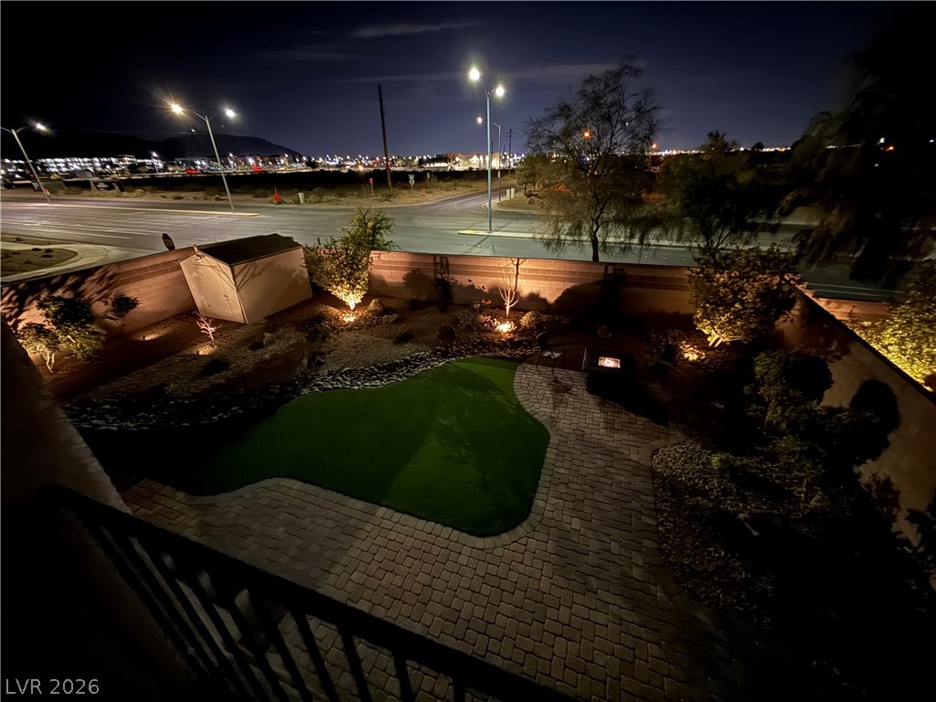 1054 Langston Ranch Avenue Henderson, NV 89002 - Photo 4 of 82 Tranquil City Lights View from primary balcony. Exquisite backyard with custom lighting. Lovely green artificial low maintenance turf.