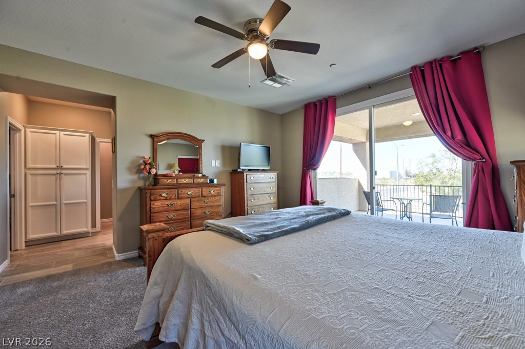 1054 Langston Ranch Avenue Henderson, NV 89002 - Photo 55 of 82 Carpeted bedroom with access to exterior and ceiling fan. Private balcony to unwind at the end of the day or to have your morning coffee or tea.