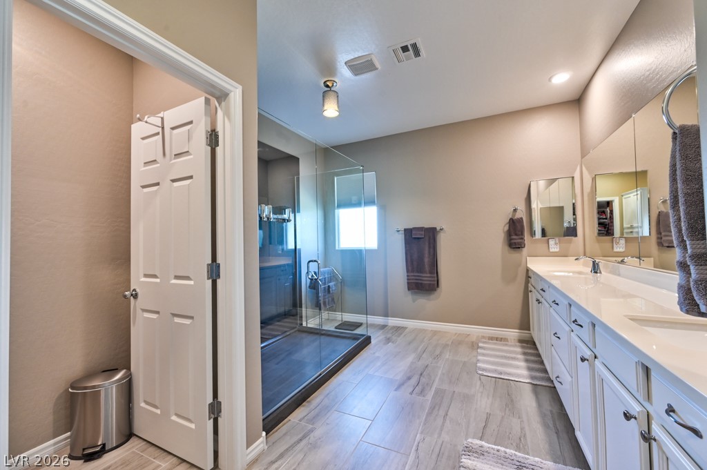 1054 Langston Ranch Avenue Henderson, NV 89002 - Photo 56 of 82 Large bathroom featuring double vanity, a custom upgraded shower and tiled floors. Separate water closet.