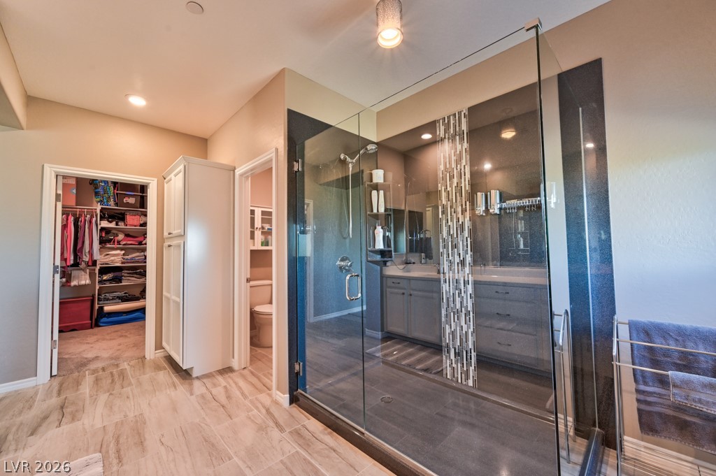 1054 Langston Ranch Avenue Henderson, NV 89002 - Photo 57 of 82 MAIN PRIMARY Bathroom featuring A DOUBLE vanity, a spacious closet, a CUSTOM UPGRADED XLARGE shower stall, and recessed lighting. LARGE STORAGE CABINETS AND ADDITIONAL MEDICINE CABINETS ADDED. $$$$ SPENT