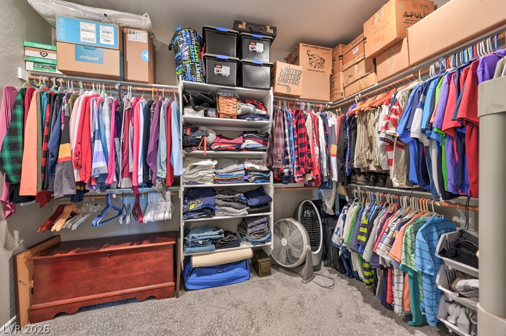 1054 Langston Ranch Avenue Henderson, NV 89002 - Photo 58 of 82 Walk in closet with light colored carpet and shelving.