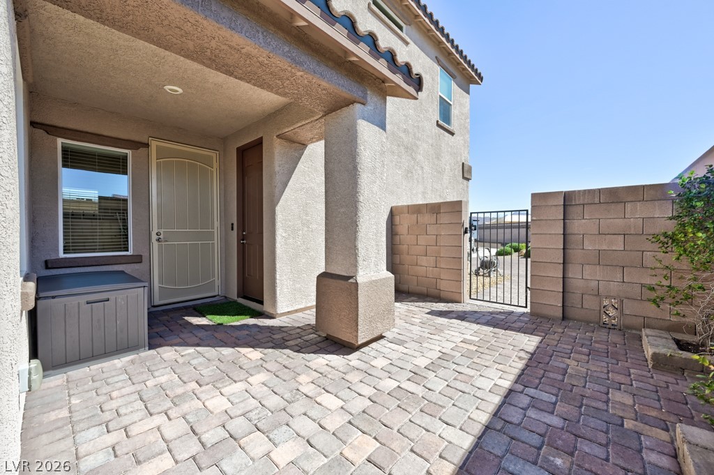 1054 Langston Ranch Avenue Henderson, NV 89002 - Photo 60 of 82 CASITA Courtyard. Private Entrance. Secured Entry. Door to enter the garage. Paver stone low maintenance.