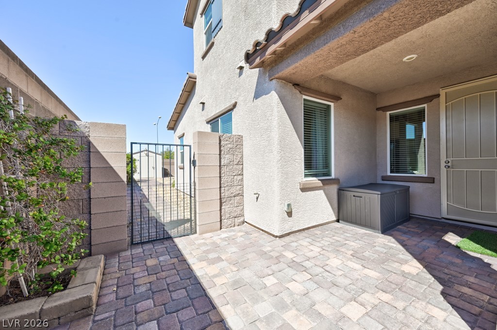1054 Langston Ranch Avenue Henderson, NV 89002 - Photo 61 of 82 View of gate leading to backyard. Courtyard patio for the casita entrance. Low e windows.