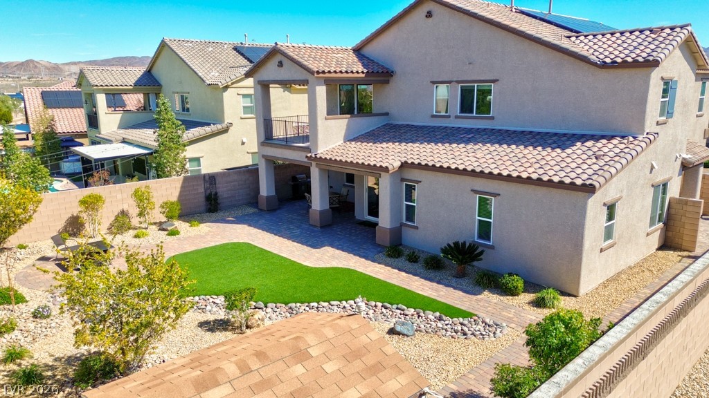 1054 Langston Ranch Avenue Henderson, NV 89002 - Photo 80 of 82 Mediterranean / spanish home with roof mounted solar panels, a patio, stucco siding, and a fenced backyard