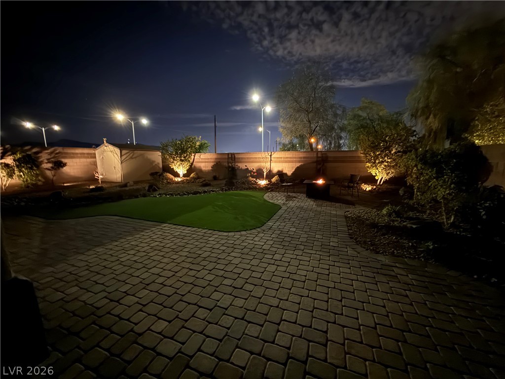1054 Langston Ranch Avenue Henderson, NV 89002 - Photo 81 of 82 BREATHTAKING backyard at twilight. Extensive Landscape and Hardscape with lighting. $$$$$ spent. You get to enjoy the amazing lifestyle this home provides.