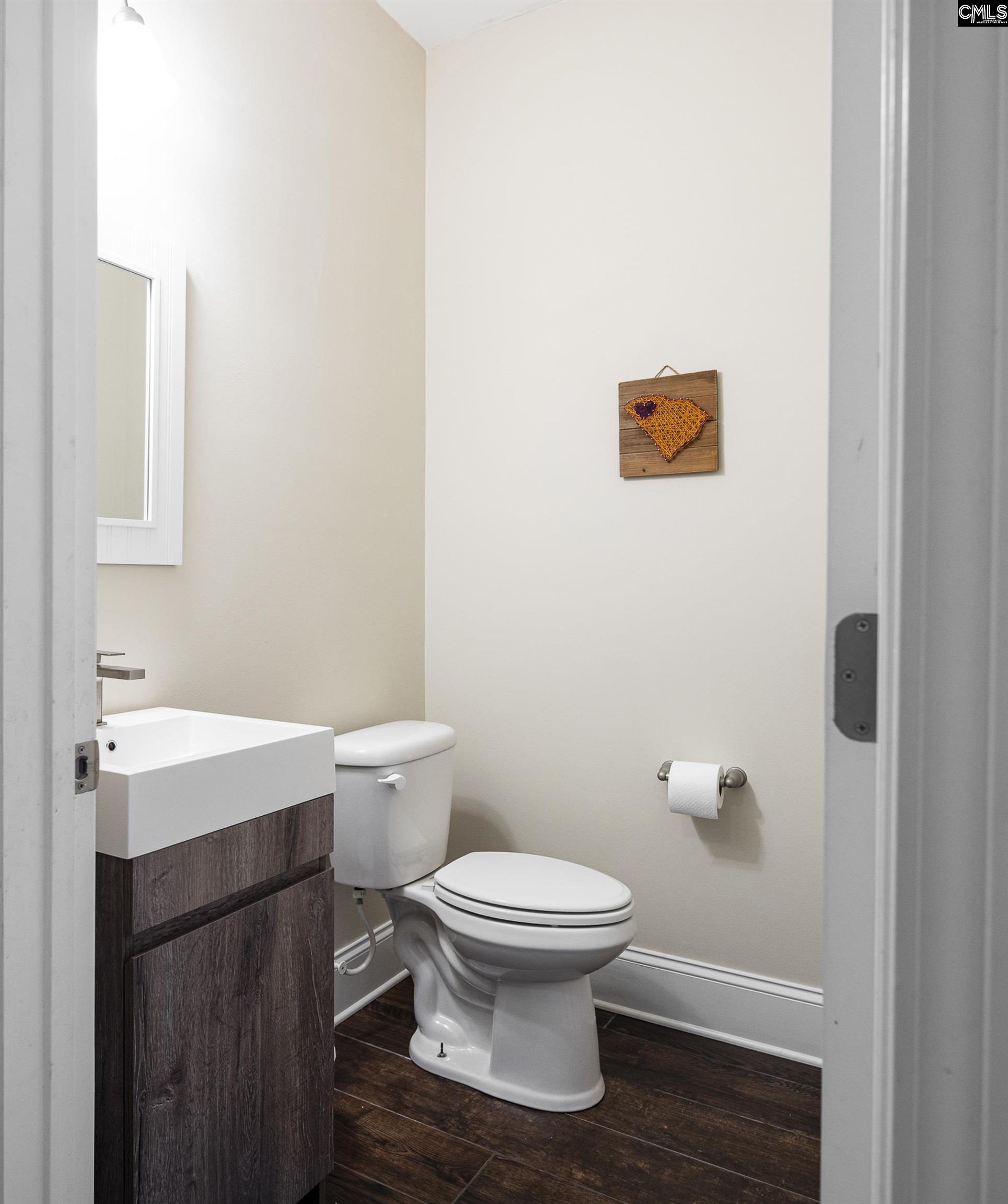 213 Sunset Point Drive Lexington, SC 29072 - Photo 16 of 35 a bathroom with a toilet a sink and mirror
