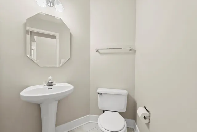 a white toilet sitting next to a bathroom sink