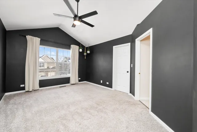 a view of a livingroom with a ceiling fan and window