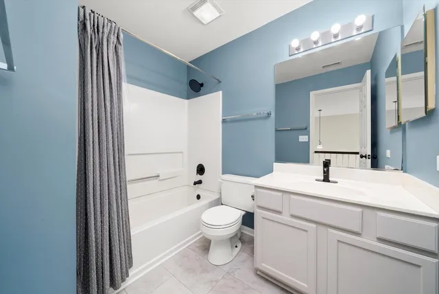 a bathroom with a sink a toilet and a large mirror