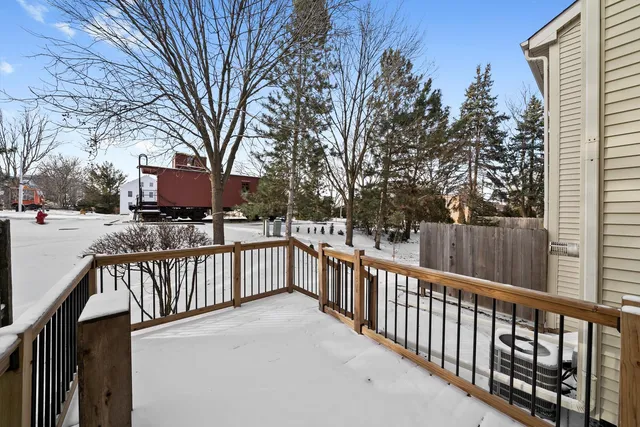 a view of a balcony with wooden fence and trees